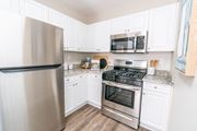 Groton apartment for rent - a kitchen with stainless steel appliances and white cabinets at The Ledges Apartment Homes, Groton, CT, 06340