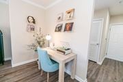 Groton apartment for rent - a bedroom with a desk and a chair and a door at The Ledges Apartment Homes, Groton, CT, 06340