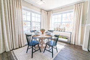 Groton apartment for rent - a dining room with a table and chairs and two windows at The Ledges Apartment Homes, Groton, CT, 06340