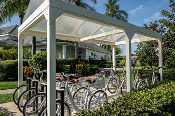 A group of bikes parked in front of a white pavilion