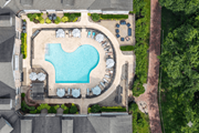 Shelton apartment for rent - A large swimming pool surrounded by lounge chairs and umbrellas.
