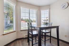 Olympia apartment for rent - a dining room with a table and chairs and windows