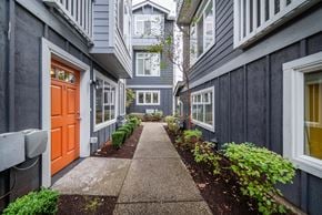 Seattle townhouse for rent - a walkway between two buildings with an orange door