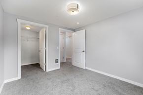 Seattle townhouse for rent - a bedroom with white walls and white doors and a carpeted floor
