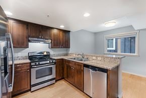 Seattle townhouse for rent - a kitchen with stainless steel appliances and granite counter tops