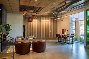 Seattle apartment for rent - a lounge area with chairs and a table in a lobby
