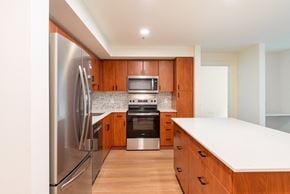 Seattle apartment for rent - a large kitchen with wooden cabinets and stainless steel appliances
