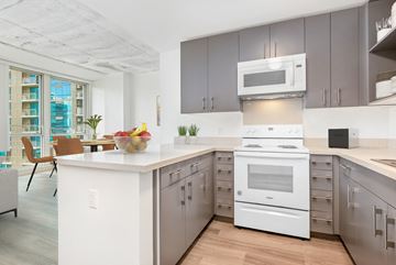 Honolulu apartment for rent - a large kitchen with white appliances and gray cabinets