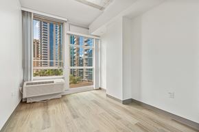 Honolulu apartment for rent - a living room with a large window and a radiator on the floor