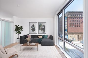 Seattle apartment for rent - a living room with a gray couch and a large window