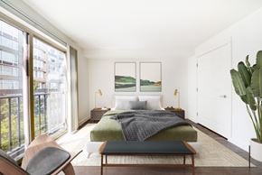 Seattle apartment for rent - a bedroom with a bed and a large window