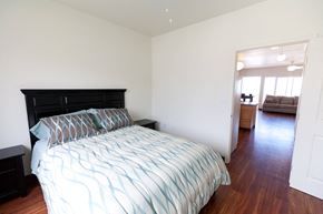 Kailua-Kona apartment for rent - a bedroom with a bed and a view of a living room and a bathroom
