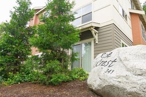 Issaquah apartment for rent - A large rock with the words "Cob West 341" written on it in front of a house.
