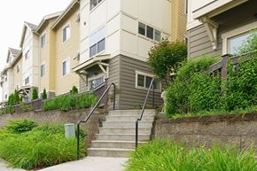 Issaquah apartment for rent - A staircase with a railing leads up to a building.