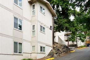 Redmond apartment for rent - A white building with a yellow curb in front of it.