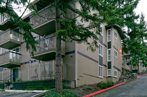 Redmond apartment for rent - Apartment building with balconies and trees in front.