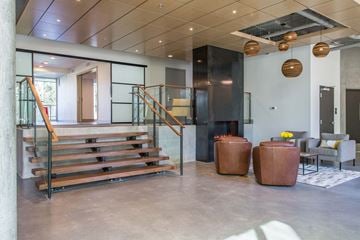 Seattle apartment for rent - the lobby of a building with a staircase and chairs and a living room