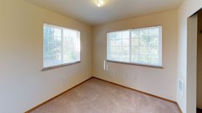 Bellingham apartment for rent - the living room of a home with two windows and carpeting