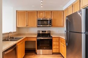 Seattle apartment for rent - A kitchen with wooden cabinets and stainless steel appliances.