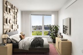 Seattle apartment for rent - a bedroom with a bed and a large window