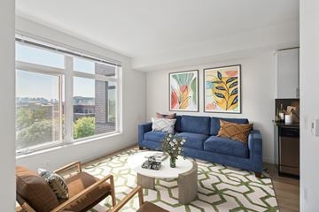 Seattle apartment for rent - a living room with a blue couch and a white coffee table