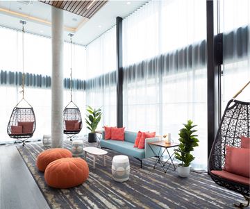 Seattle apartment for rent - a living room with couches and chairs and large windows