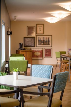 Seattle apartment for rent - a dining room with tables and chairs and pictures on the wall