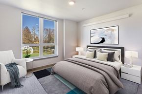 Seattle apartment for rent - a bedroom with a bed and a large window