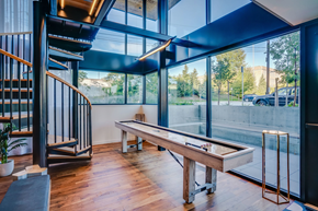Seattle apartment for rent - a pool table in a room with glass walls and a staircase