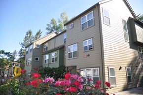 Bellevue apartment for rent - A building with a green lawn in front of it.