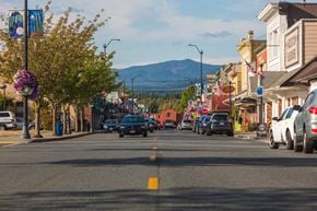 Arlington apartment for rent - a city street with cars and buildings and mountains in the background