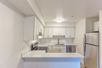 Bellingham apartment for rent - A white kitchen with a refrigerator on the right.