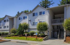 Ferndale apartment for rent - a white apartment building with a sidewalk and trees