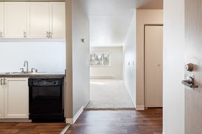 Bremerton apartment for rent - a kitchen with white cabinets and a black dishwasher