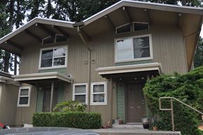 Bellevue apartment for rent - A house with a grey exterior and a brown door.