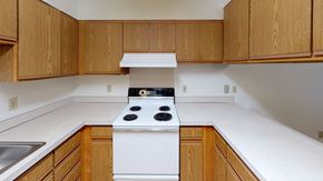 Bellingham apartment for rent - an empty kitchen with white appliances and wooden cabinets