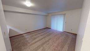 Bellingham apartment for rent - an empty living room with carpet and a sliding glass door