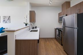 Auburn apartment for rent - a kitchen with a white counter top and a stainless steel refrigerator