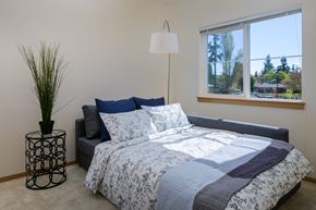 Auburn apartment for rent - a bedroom with a bed and a lamp and a window