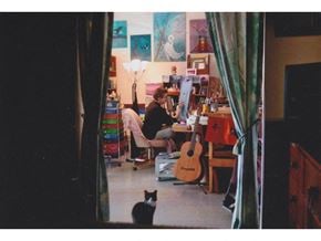 Everett apartment for rent - a woman sitting at a desk with a cat in the foreground