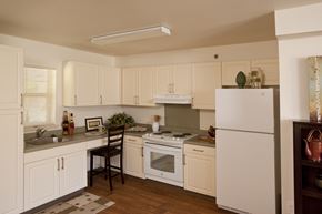 Ewa Beach apartment for rent - a kitchen with white cabinets and appliances and a counter top
