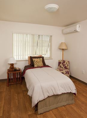 Ewa Beach apartment for rent - a bedroom with a bed and a chair and a window