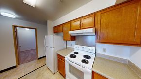 Ferndale apartment for rent - a kitchen with white appliances and wooden cabinets and a white refrigerator