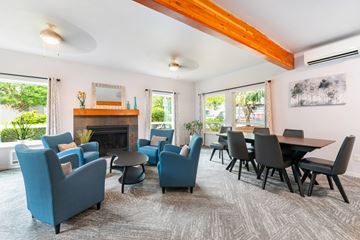 Issaquah apartment for rent - A living room with blue chairs and a fireplace.