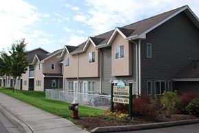 Bellingham apartment for rent - a row of townhouses with a sign in front of a sidewalk