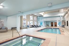 Lynnwood apartment for rent - a large indoor swimming pool with a jacuzzi and a poolside spa
