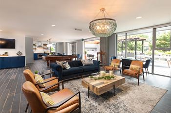 Speakeasy style community lounge with flat screen tvs & fully equipped culinary kitchen