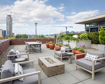 Rooftop terrace with an outdoor fireplace, fire pit & high-end outdoor grilling station