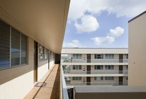 Honolulu apartment for rent - a view of a building from a balcony in a building with a blue sky