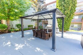 Bremerton apartment for rent - a patio with a table and chairs under a gazebo